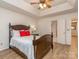 Bright bedroom with a tray ceiling, ceiling fan and a closet, leading into bathroom at 4801 Pennant Pl, Charlotte, NC 28212