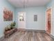 Well-lit mud room with stylish flooring, bench, and access to the backyard at 4801 Pennant Pl, Charlotte, NC 28212