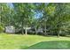 Expansive backyard featuring lush greenery and mature trees, perfect for outdoor activities and relaxation at 5611 Robinhood Rd, Charlotte, NC 28211