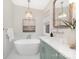Inviting bathroom features a freestanding tub, stylish light fixtures, and luxurious design at 5611 Robinhood Rd, Charlotte, NC 28211