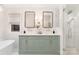 Bright bathroom with double sink vanity, stylish mirrors, and a glass-enclosed shower at 5611 Robinhood Rd, Charlotte, NC 28211