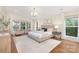 Spacious bedroom with hardwood floors, neutral colors, large windows, and recessed lighting at 5611 Robinhood Rd, Charlotte, NC 28211