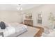 Comfortable bedroom featuring hardwood floors, a cozy rug, and en-suite bathroom at 5611 Robinhood Rd, Charlotte, NC 28211
