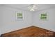 Bright bedroom featuring hardwood floors and two windows for natural light at 5611 Robinhood Rd, Charlotte, NC 28211