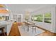 Bright dining room with a stylish chandelier, hardwood floors, and seamless flow into the kitchen at 5611 Robinhood Rd, Charlotte, NC 28211