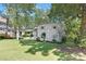 Stately home with a landscaped front yard and mature trees offering shade at 5611 Robinhood Rd, Charlotte, NC 28211