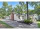 Side view of a charming brick and white home with a private driveway at 5611 Robinhood Rd, Charlotte, NC 28211