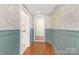 Welcoming hallway with hardwood floors, wainscoting, and stylish wallpaper design at 5611 Robinhood Rd, Charlotte, NC 28211