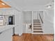 Hallway with hardwood floors leading towards the staircase and kitchen area at 5611 Robinhood Rd, Charlotte, NC 28211