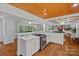 Open-concept kitchen with marble countertops, hardwood floors, and seamless flow into the living area at 5611 Robinhood Rd, Charlotte, NC 28211
