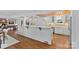 Modern kitchen featuring an open layout, white cabinetry, hardwood floors, and a kitchen island at 5611 Robinhood Rd, Charlotte, NC 28211
