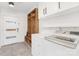 Modern laundry room with ample storage and a convenient washer and dryer setup at 5611 Robinhood Rd, Charlotte, NC 28211