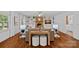 Inviting living room featuring a brick fireplace, built-in shelving, and hardwood floors at 5611 Robinhood Rd, Charlotte, NC 28211