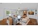 Bright living room showcasing a brick fireplace, built-in shelves, and natural light from windows at 5611 Robinhood Rd, Charlotte, NC 28211