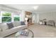 Inviting living room with brick fireplace, bright windows, and comfortable seating at 5611 Robinhood Rd, Charlotte, NC 28211