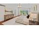 Comfortable main bedroom with natural light, a sitting area, and hardwood floors at 5611 Robinhood Rd, Charlotte, NC 28211