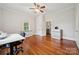Light-filled bedroom with hardwood floors, fresh paint, storage, and access to other rooms at 626 Cabarrus W Ave, Concord, NC 28027