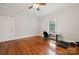 Bright bedroom featuring hardwood floors, neutral paint, a ceiling fan, and ample sunlight at 626 Cabarrus W Ave, Concord, NC 28027