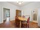 Open dining room with a vintage hutch, hardwood floors, and access to other rooms at 626 Cabarrus W Ave, Concord, NC 28027
