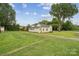 Spacious lot with a view of a modest single-story home and surrounding greenery at 626 Cabarrus W Ave, Concord, NC 28027