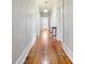 Long hallway featuring hardwood floors and providing access to various rooms at 626 Cabarrus W Ave, Concord, NC 28027