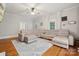 Bright living room features hardwood floors, a large sectional couch, and a ceiling fan at 626 Cabarrus W Ave, Concord, NC 28027