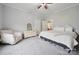 Spacious carpeted bedroom features a chair, dresser, and easy access to the living room at 626 Cabarrus W Ave, Concord, NC 28027