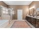 Spacious bathroom with glass shower, soaking tub, double vanity, and neutral color scheme at 6506 Jepson Ct # 349, Charlotte, NC 28214