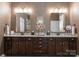 Elegant bathroom with double vanity, granite countertop, dark wood cabinets and modern fixtures at 6506 Jepson Ct # 349, Charlotte, NC 28214