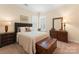 Comfortable bedroom featuring shuttered windows, a plush bed, and neutral tones at 6506 Jepson Ct # 349, Charlotte, NC 28214