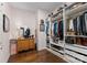 Walk-in closet with hardwood floors, custom shelving, and soft pink walls at 6506 Jepson Ct # 349, Charlotte, NC 28214