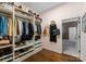 Organized walk-in closet with custom shelving, hanging space, and hardwood floors at 6506 Jepson Ct # 349, Charlotte, NC 28214