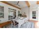 Elegant outdoor dining area with a ceiling fan, sliding glass doors, and well-appointed table setting at 6506 Jepson Ct # 349, Charlotte, NC 28214
