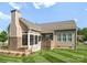 Exterior back view featuring a screened-in porch with a stone fireplace, offering a private outdoor space at 6506 Jepson Ct # 349, Charlotte, NC 28214