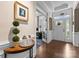 Inviting foyer with hardwood floors, transom window, white door, and trim, all illuminated by abundant natural light at 6506 Jepson Ct # 349, Charlotte, NC 28214