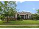 Beautifully landscaped front yard featuring a lush lawn and mature trees framing the home at 6506 Jepson Ct # 349, Charlotte, NC 28214