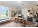 Bright home office featuring a large window, a unique desk, and custom shelving at 6506 Jepson Ct # 349, Charlotte, NC 28214