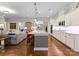 Well-lit kitchen featuring a large island with seating, stainless steel appliances, and ample storage space at 6506 Jepson Ct # 349, Charlotte, NC 28214