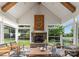 Inviting sunroom with stone fireplace, vaulted ceilings, wood beams, and plenty of natural light at 6506 Jepson Ct # 349, Charlotte, NC 28214