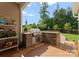Outdoor kitchen featuring stone accents, stainless steel appliances, and a built-in grill, perfect for entertaining at 6506 Jepson Ct # 349, Charlotte, NC 28214