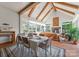 Bright sunroom with vaulted ceilings, wood beams, stone fireplace, ample seating, and large windows at 6506 Jepson Ct # 349, Charlotte, NC 28214