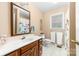 Bathroom featuring a neutral color scheme, a vanity with dark wood cabinets, and a white tile floor at 7029 Forest Hills Dr # 38, Denver, NC 28037