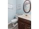 Bathroom with blue walls, a toilet, a vanity with a dark wood cabinet, and an oval mirror at 7029 Forest Hills Dr # 38, Denver, NC 28037