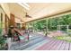 Relaxing covered porch with outdoor seating overlooking the garden area with its landscaping and greenery at 7029 Forest Hills Dr # 38, Denver, NC 28037