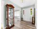 Inviting foyer featuring a display cabinet, wood flooring, and a white front door at 7029 Forest Hills Dr # 38, Denver, NC 28037