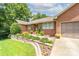 Charming single-story brick home with a well-manicured lawn and an inviting stone-lined walkway at 7029 Forest Hills Dr # 38, Denver, NC 28037