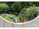 Lush flowers and greenery surround a gate, adding charm to the outdoor space at 7029 Forest Hills Dr # 38, Denver, NC 28037