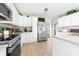 Bright kitchen featuring white cabinets, stainless steel appliances, tile flooring, and lots of cabinet space at 7029 Forest Hills Dr # 38, Denver, NC 28037