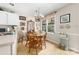 Eat-in kitchen with white cabinets, stainless steel appliances, a window, and tile flooring at 7029 Forest Hills Dr # 38, Denver, NC 28037