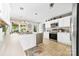 Open-concept kitchen with stainless steel appliances, white cabinetry, and a view to the eat-in dining area at 7029 Forest Hills Dr # 38, Denver, NC 28037